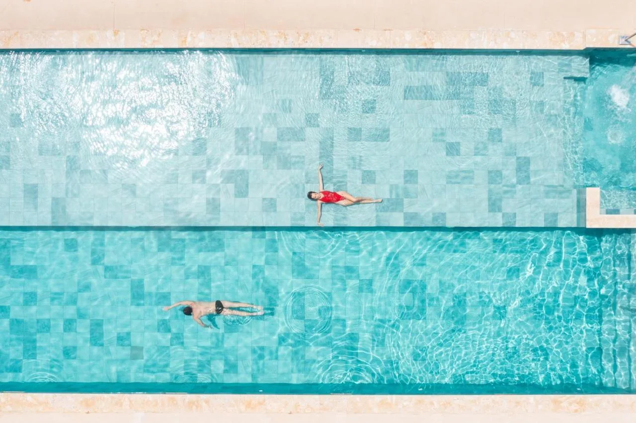 Guests floating in the pool, from above